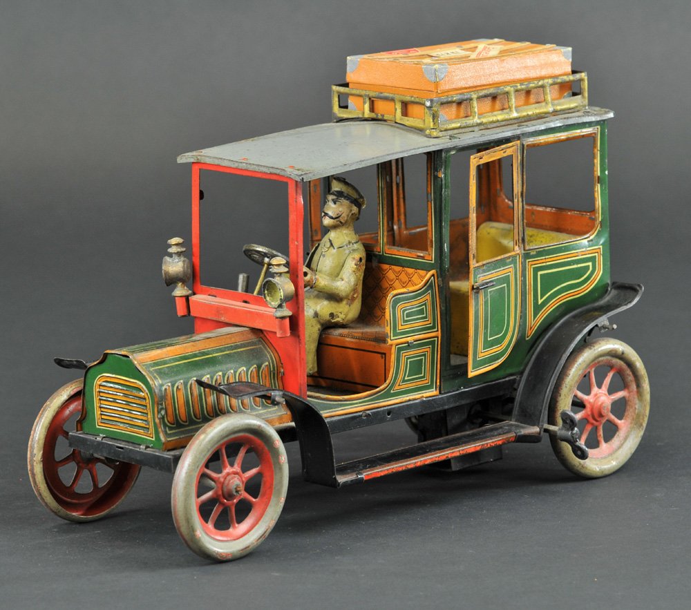 HANS EBERL LIMOUSINE: Germany, c. 1915, lithographed tin, luxury tin example w/full running boards, opening doors, luggage rack, front mounted side lanterns, seated driver, clockwork driven. 11 1/4" l.