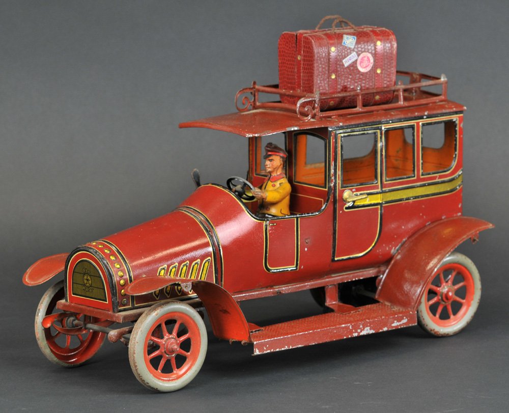 HANS EBERL LIMOUSINE: Germany, c. 1910, large maroon body limousine w/gold color striping, features roof rack, seated driver, full running boards, and rivet design grille, spoke wheels done in red, clockwork driven, strong