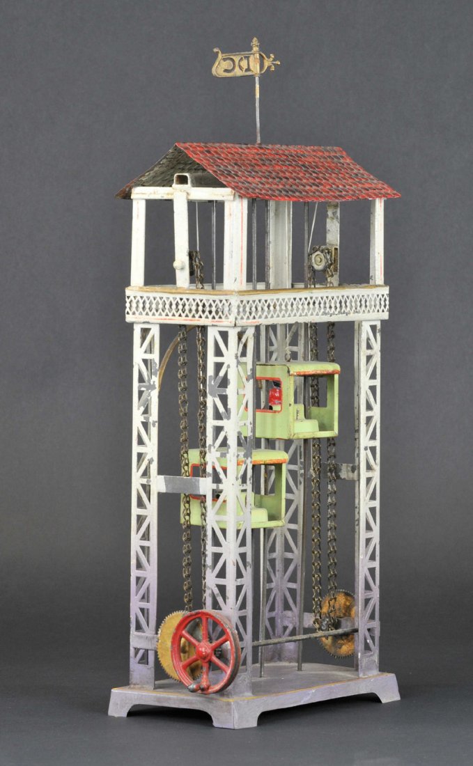 DOLL & CO. LIFT TOY: Germany, hand painted tin, an interesting split box, elevators w/interior seating, side lever w/chain drive. 16" h.