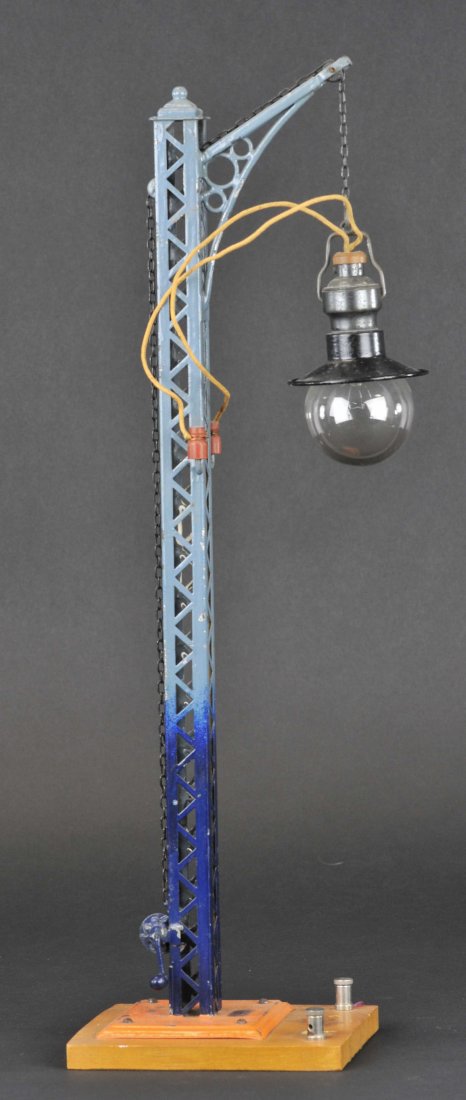 BING TRESTLE TOWER LAMP: Germany, hand painted in shades of blues, globe lamp hangs from chain, tin shade done in black, electrified example, single arc extends from pole for street lighting. 19" h.