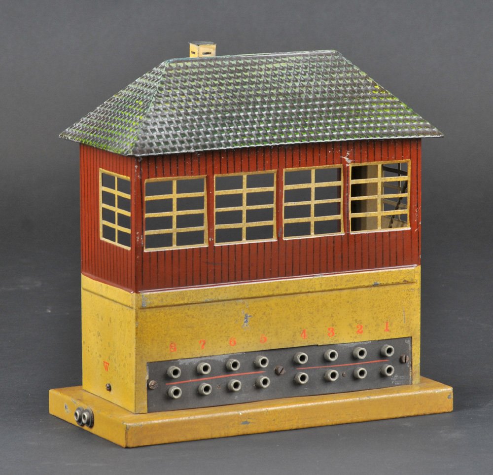 MARKLIN POWER SWITCH TOWER BUILDING: Embossed lithographed tin, c. 1930, rubber stamped catalog number on base reads, "1382/8," features sixteen connection ports, and windows on three sides. 9 1/2" h.