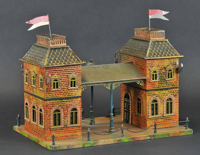 CARETTE GAUGE 'I' TRAIN STATION: Germany, c. 1907, hand painted, extensive embossed façade stamping, very ornate & perfect scale, depicts parallel ticket station in two-story housing, sharing ribbed canopy with central clock; nicely