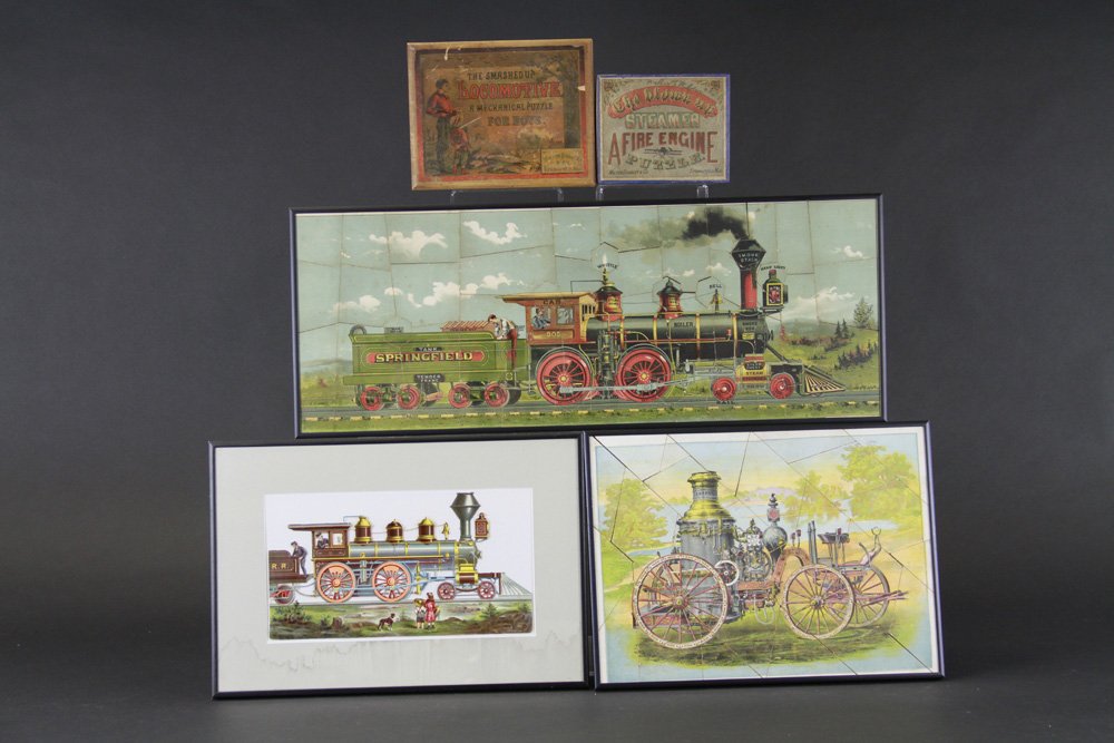 LOCOMOTIVE DIE-CUT AND TWO PUZZLES: Lot includes box Steamer Fire Engine Puzzle, "Smashed Up Locomotive" Puzzle, and colorful die-cut images, all framed under glass. 12" - 15" and 26" l.