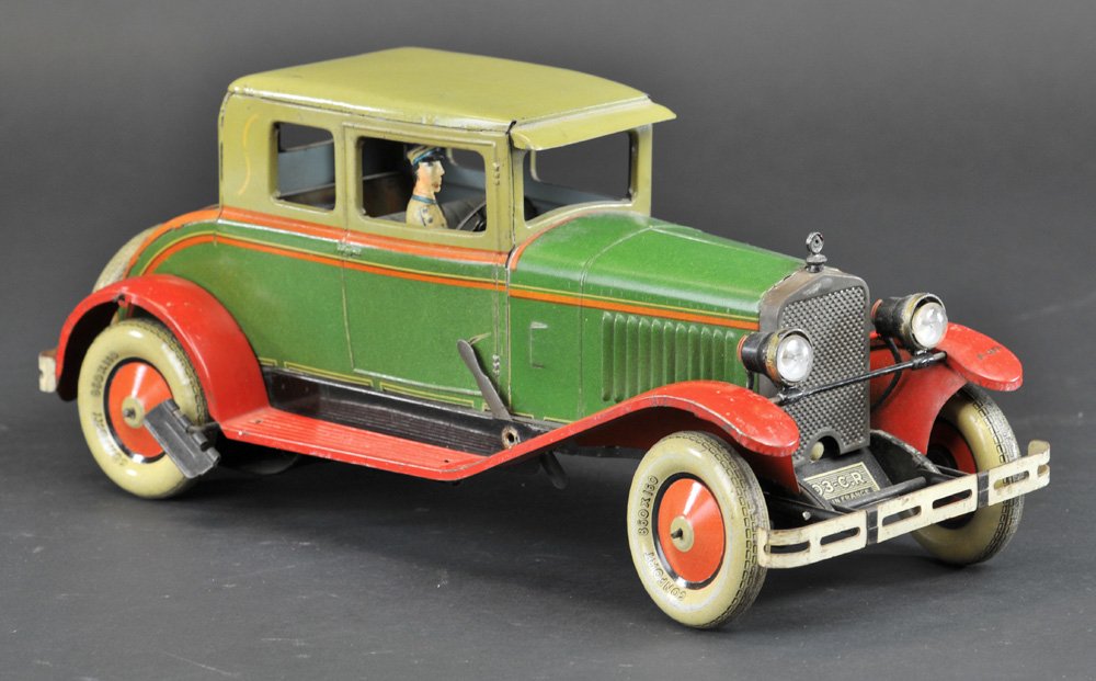 CHARLES ROSSIGNOL COUPE: France, 1930's, lithographed tin, green body, olive green roof, red fenders, features electric lights, opening trunk door, clockwork mechanism. 14 1/2" l.