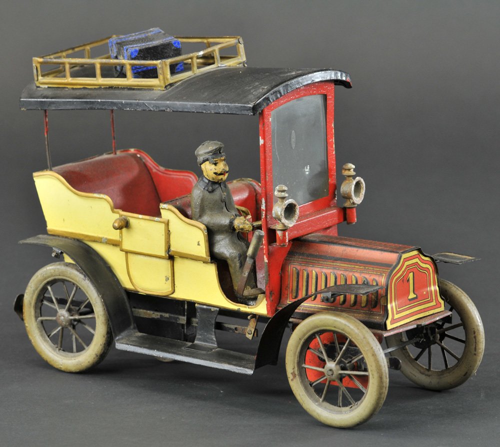 HANS EBERL LIMOUSINE: Germany, c. 1920, lithographed tin, done in cream body, black roof, seated driver, spoke wheels, bonnet is lithographed, features luggage rack side lanterns, clockwork operated. 10" l.
