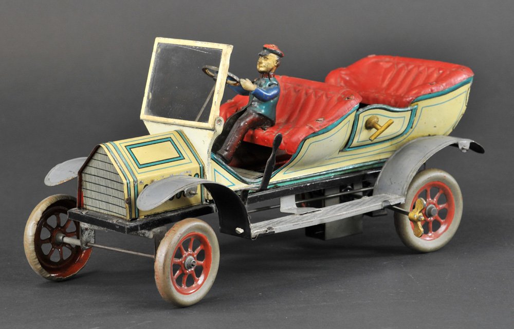 FOUR SEAT OPEN TOURER: Germany, lithographed tin, Hans Eberl, done in white body w/blue trim, red embossed seating, opening doors, spoke wheels, a good sized luxury auto, clockwork mechanism, nice styling overall. 13 1/4" l