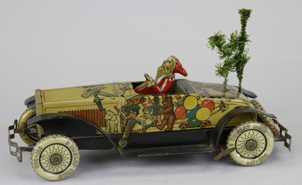 TIPPCO SANTA CLAUS AUTO: Germany, c. 1928, one of the most desirable lithographed tin auto toys produced, this exceptional open auto features Santa at the wheel w/extensive graphic images of toy bag on bench seat, trunk featu