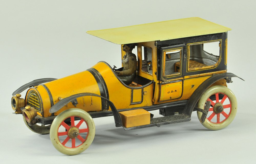 J.D.P. TAXI: France, an early Jouets de Paris example, yellow tin lithography, bright colors, grey roof, black trim, seated driver, cast headlamps, embossed tin seating, opening doors, clockwork driven, rear lante