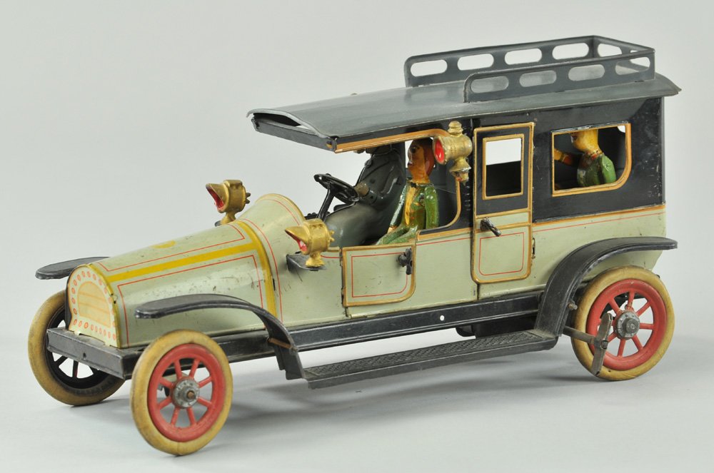 GUNTHERMANN LIMOUSINE: Germany, lithographed tin luxury auto, done in grey colors, features opening doors, seated driver, four cast lanterns, clockwork driven, grey roof has luggage rack, rubber tires w/spoke wheels. 12" l.
