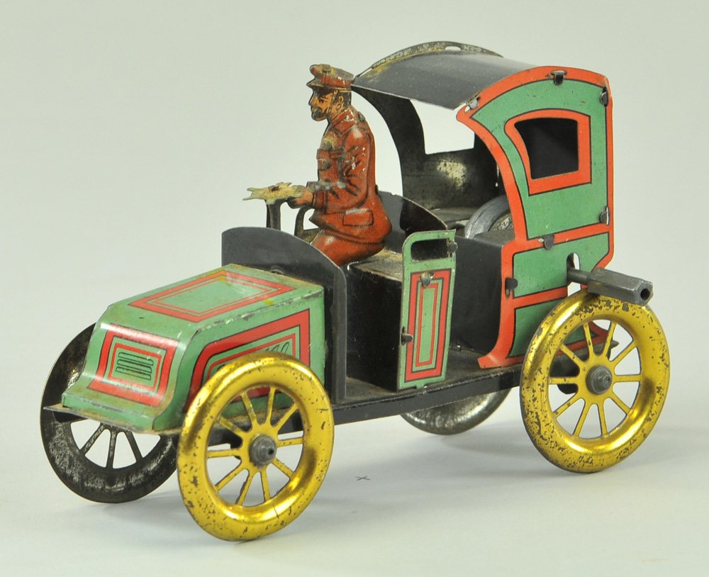 HESS TAXI: Germany, c. 1910, lithographed tin, done in typical green and red colors familiar with Hess patterns, seated driver, coach style cab, flywheel powered. 5" l.
