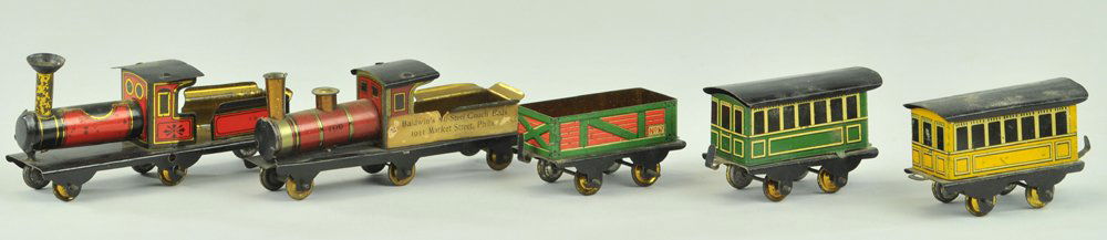 TRAIN SET PENNY TOY: Lithographed tin, example includes two locomotives, stake car and two coaches, metal wheels. 22" l.