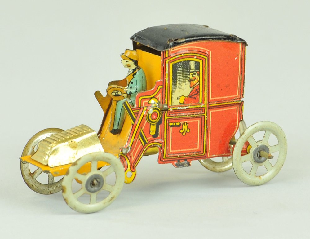 EARLY MEIER TAXI CAB: Red cab depicts gentleman and family at windows and blue uniformed driver. Ex. Donald Kaufman Collection. 3 1/8" l.