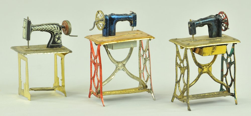 SEWING MACHINE PENNY TOYS: Blue painted tin sewing machine, together w/lithographed example, each on solo upright stand, all three have turning handles. 3 1/4" h.