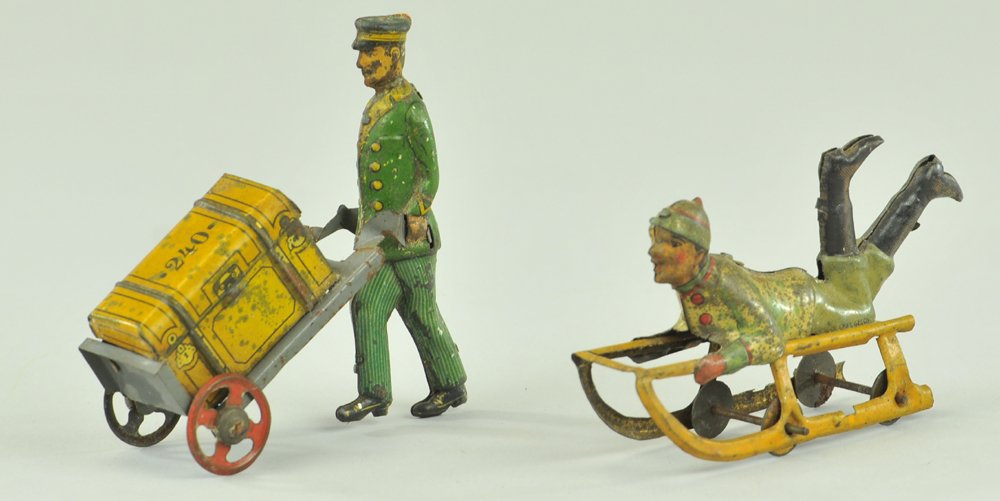 PORTER WITH LUGGAGE & BOY ON SLED PENNY TOY: Germany, lithographed tin, full figure of porter pushing hand cart containing suitcase, together with classic depiction of boy on sled, both lithographed tin. 3 1/4" l.