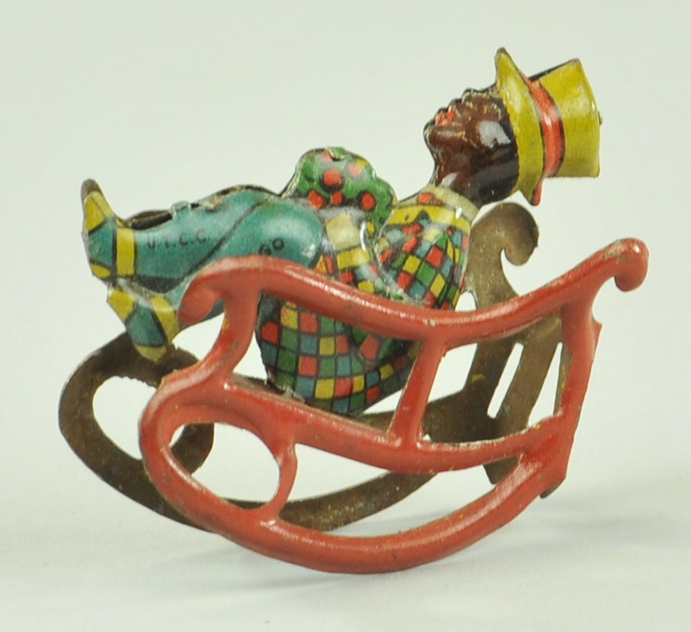 MAN IN ROCKING CHAIR PENNY TOY: Germany, lithographed tin, depicted in long slider type chair w/legs held at front of chair, very colorful. 2 1/2" l.