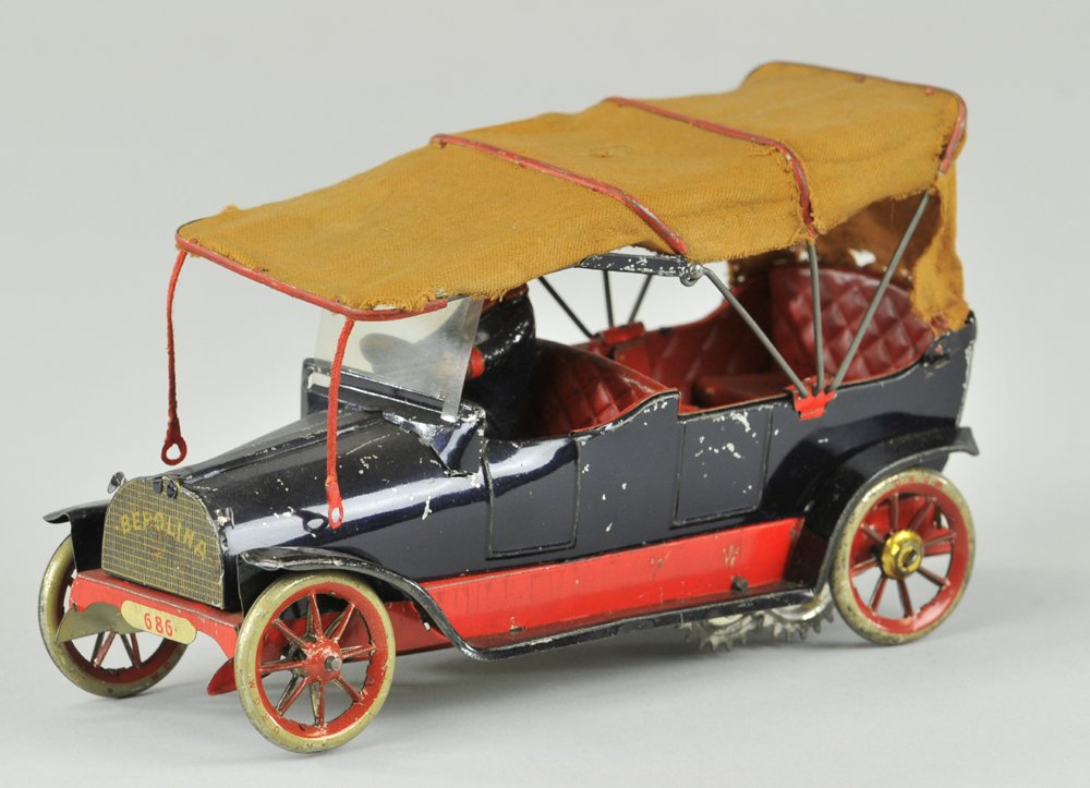 LEHMANN BEROLINA TOURING AUTO: Germany, made special for the Berlin department store Tietz, an exceptionally detailed auto, done in blue tin plate, red trim, cloth folding top, seated driver, clockwork driven, flag once appeared on