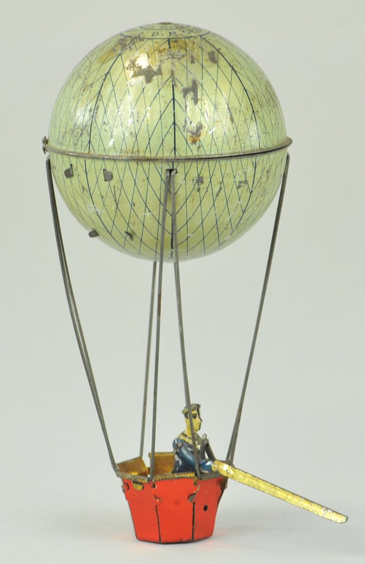 HOT AIR BALLOON: Germany, tin hot air balloon w/gondola and figure, string allows rising and lowering motions, flag once appeared from gondola, only has pole at present, this toy is recognized as a Lehmann but never c