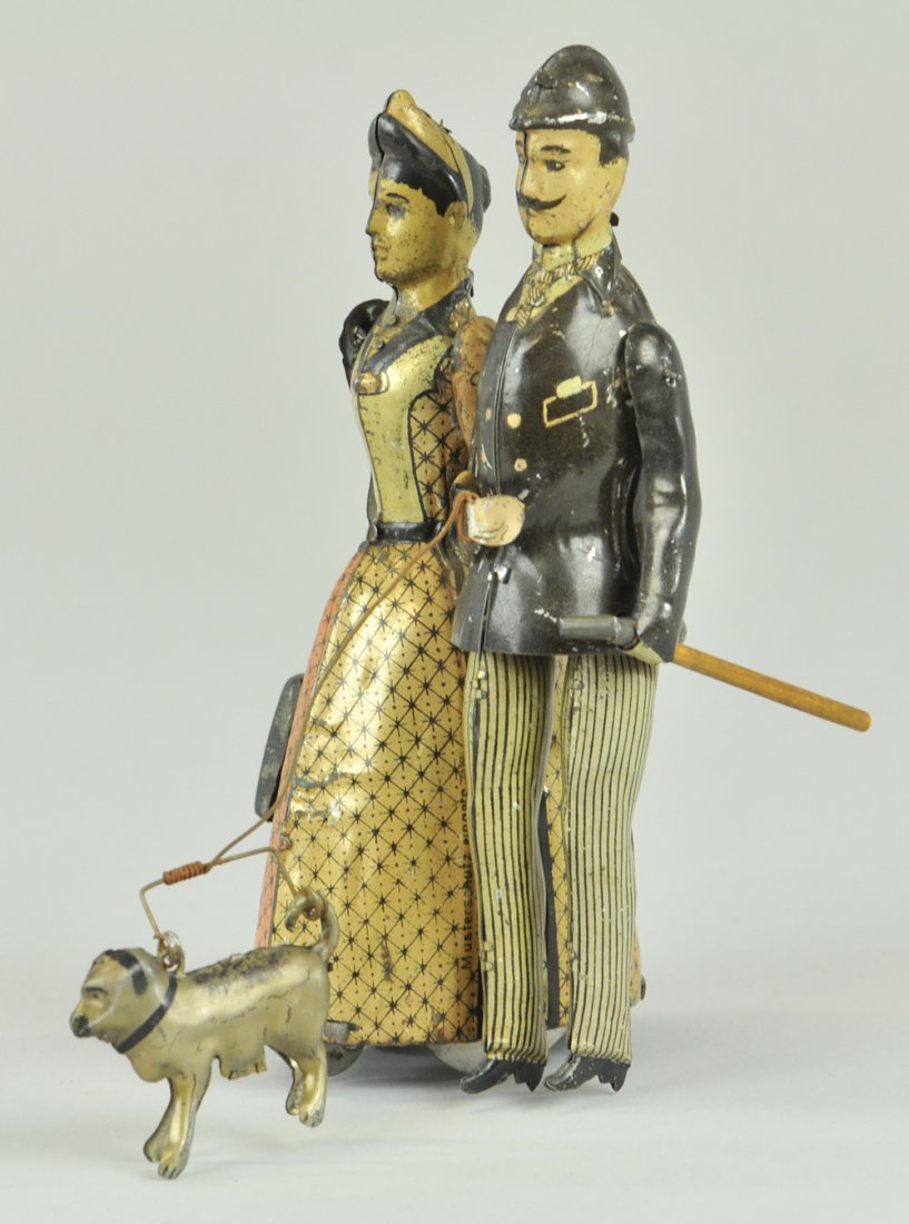 LEHMANN FAMILY WALKING DOWN BROADWAY: Germany, very realistic rendition of people in every day activity, lithographed tin, toy depiction of couple walking casually along, action involves flywheel on cogwheel located under woman's purse be