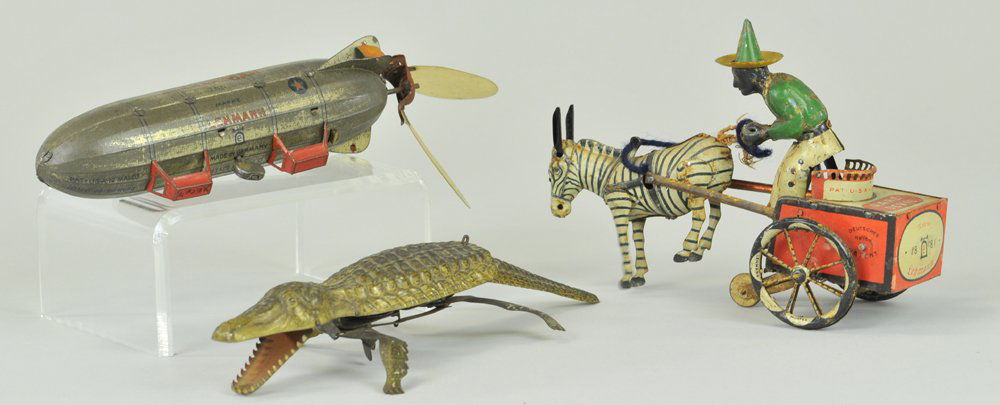 LOT OF THREE LEHMANN TOYS: Germany, lithographed tin examples, includes the popular Alligator, Shenandoah Zeppelin, and Dare Devil Zebra drawn cart, all key wind activated. 6 1/2" - 7 1/2" l.