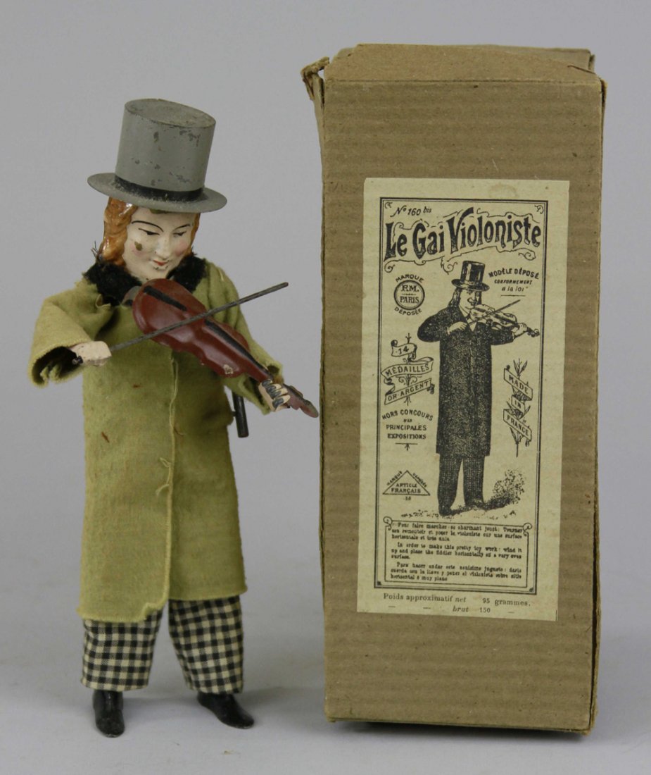 FERDINAND MARTIN BOXED VIOLINIST TOY: France, c. 1896, cloth dressed, hand painted tin head, hat & violin, incredible clockwork action, this is the early version with stamped hat, lead feet. 8 1/4" h.