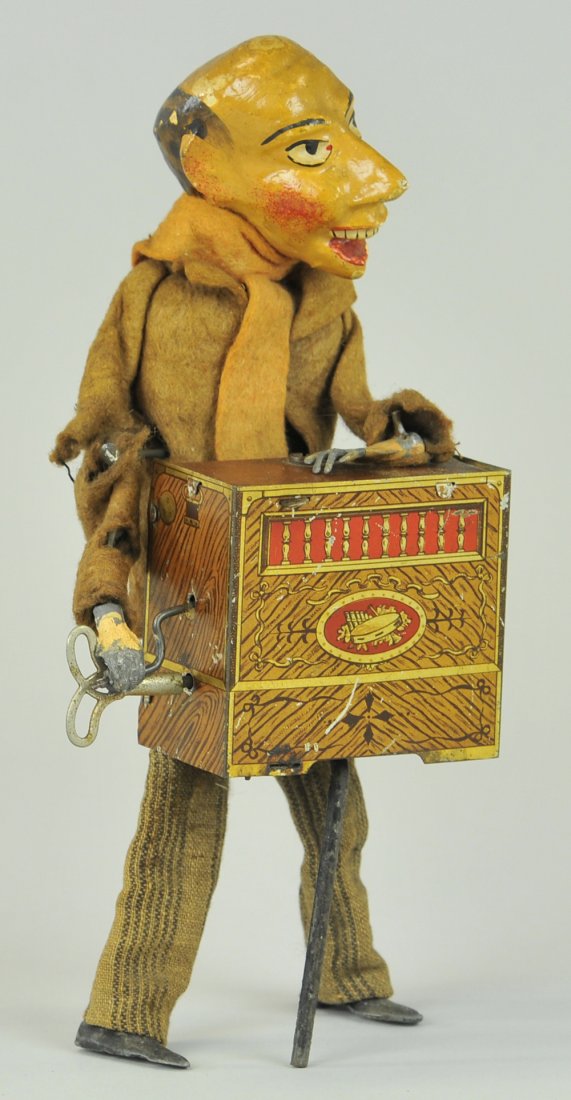 MARTIN ORGAN GRINDER: France, hand painted composition head, lithographed tin organ, wears cloth outfit, quite whimsical, clockwork driven. 9" h.