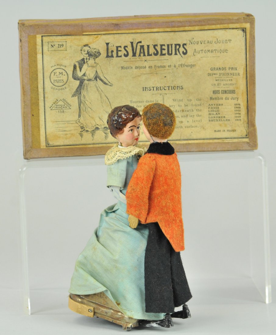 MARTIN BOXED DANCING COUPLE: France, hand painted duet, appears to dance a Waltz when clockwork is activated, striking paint condition, woman wears cloth dress, man in felt suit, box reads, "Les Valseurs". Box 4 1/2" x 8".