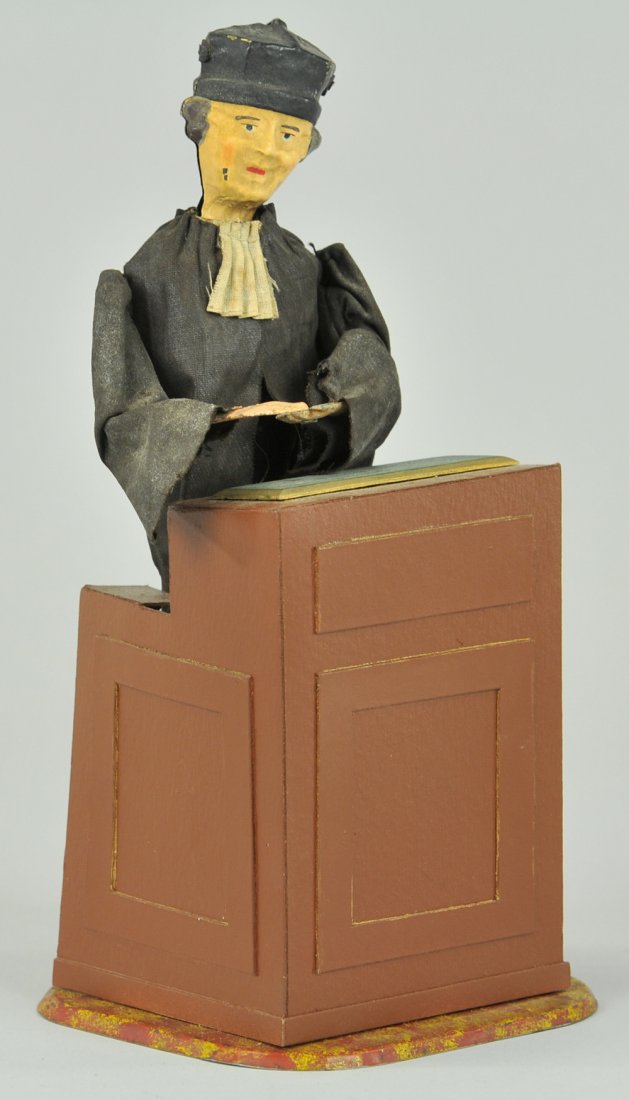 THE ADVOCATE: Ferdinand Martin, France, lithographed tin podium w/standing figure, hand painted tin head, cloth suit, when clockwork is activated figure begins to raise arms and turn body at anyone willing to liste