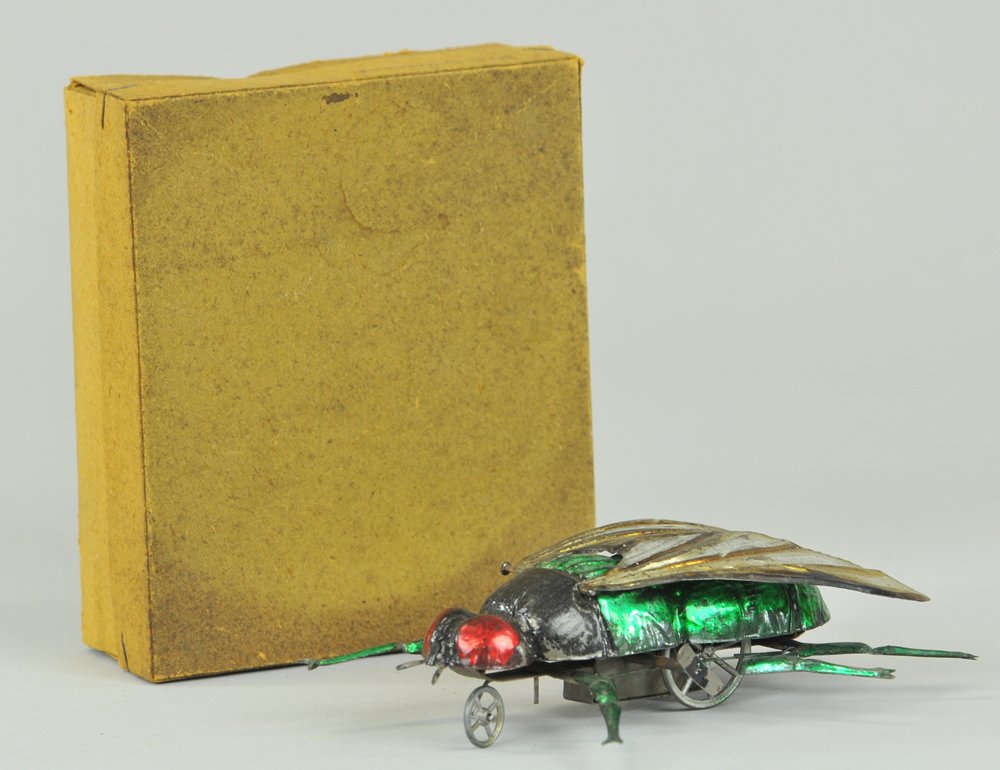 MECHANICAL FLY TOY IN BOX: Germany, spirit painted, flapping wings, clockwork mechanism w/spoke wheels. 5 1/2" l.