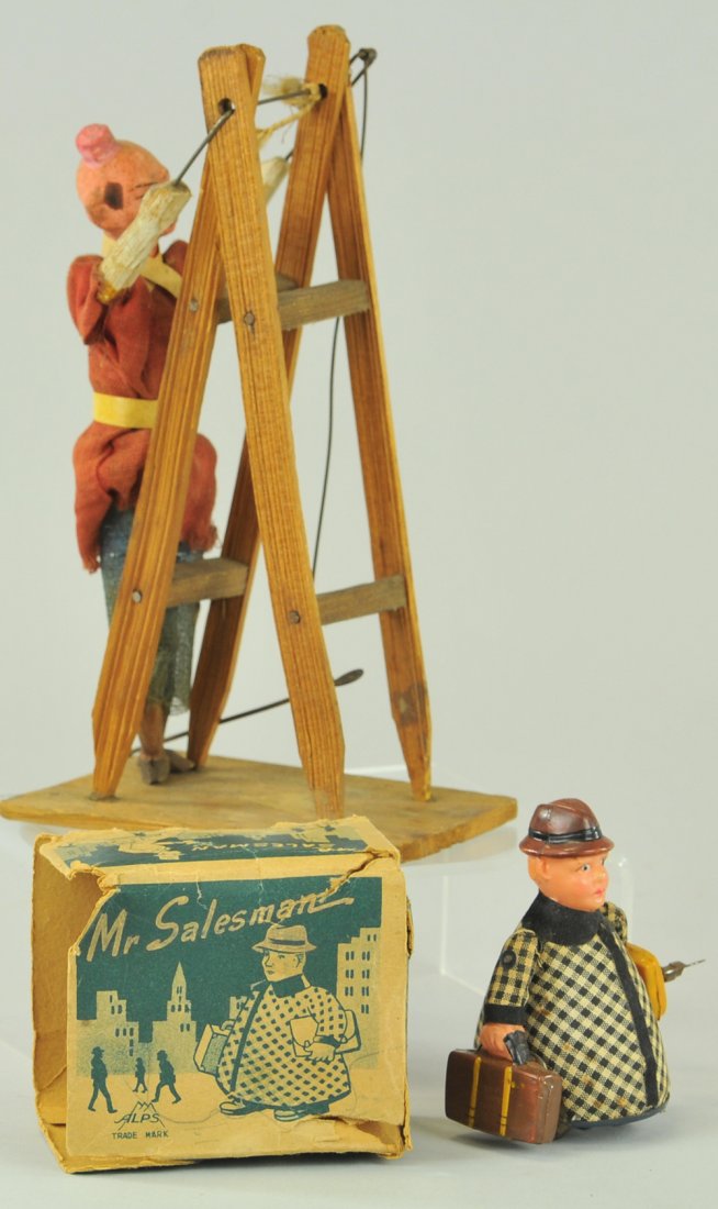 HAPPY HOOLIGAN & SALESMAN TOY: Lot includes wooden figure of Happy Hooligan on acrobatic ladder support, composition head, cloth outfit, and Japan tin salesman figure toy with wind-up action and tattered box. 3 1/4" - 7 1/2".