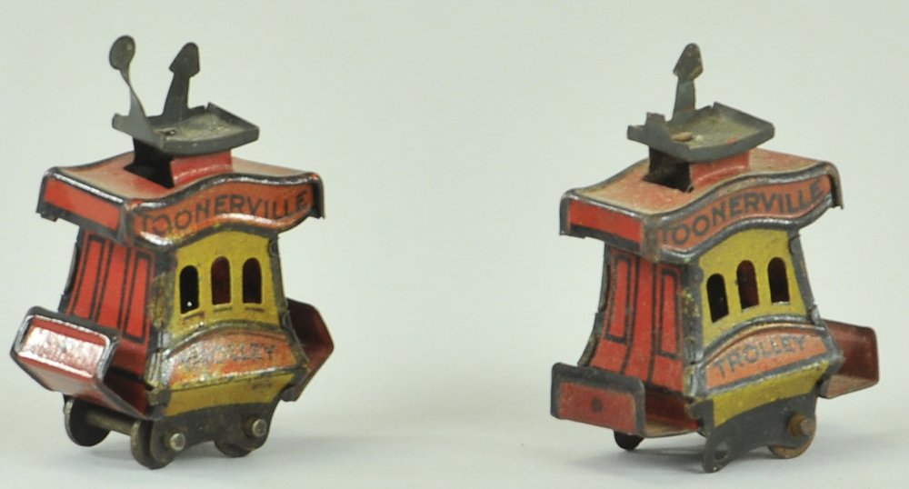 TWO TOONERVILLE CRACKER JACK TROLLEY PENNY TOYS: © Fontaine Fox, lithographed tin, Cracker Jack version of popular toy, sits on wheeled base, includes additional example, missing wheels, could be great candidate for parts. 1 3/4" l.