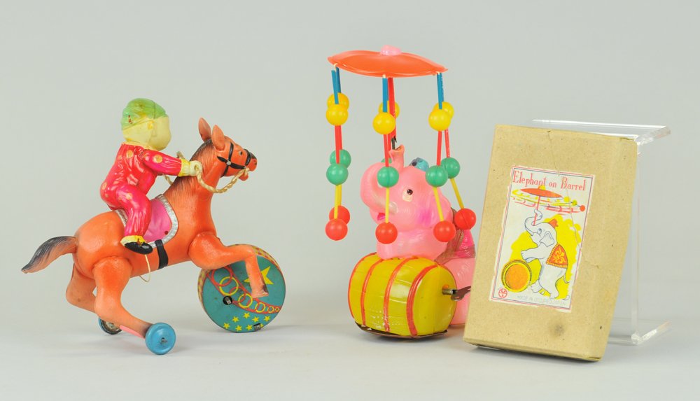 TWO CELLULOID TOYS: Japan, includes performing elephant w/barrel whirligig, and clown riding horse w/spinning tin litho drum, key wind operated. 6" - 7" l.