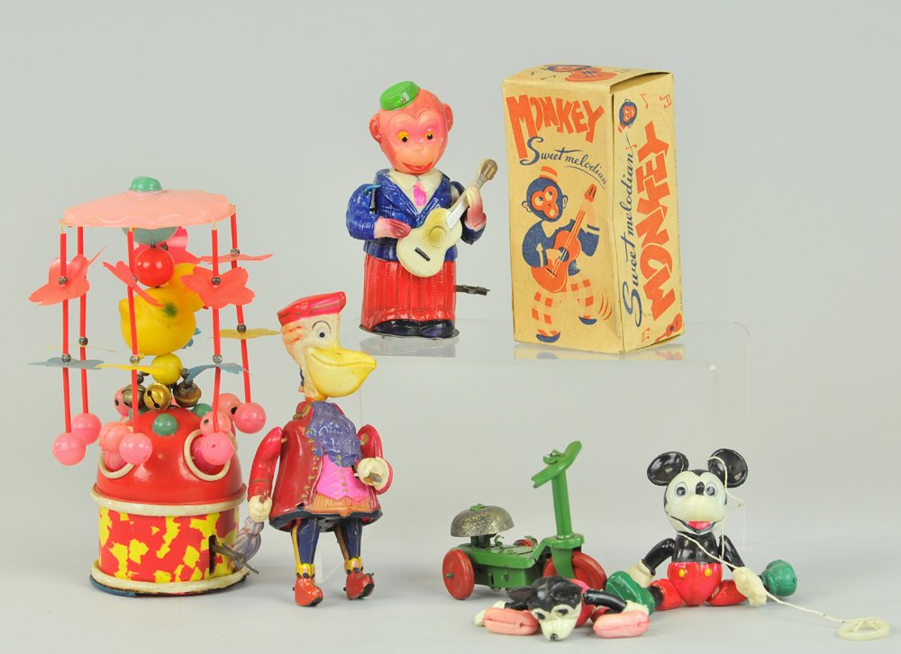 CELLULOID TOY GROUPING: Japan, lot includes: animal whirligig, Monkey playing guitar w/box, Walking Pelican, in need of minor head restoration to body, and two Mickey figures w/one added scooter. All key wind operated. Box 4