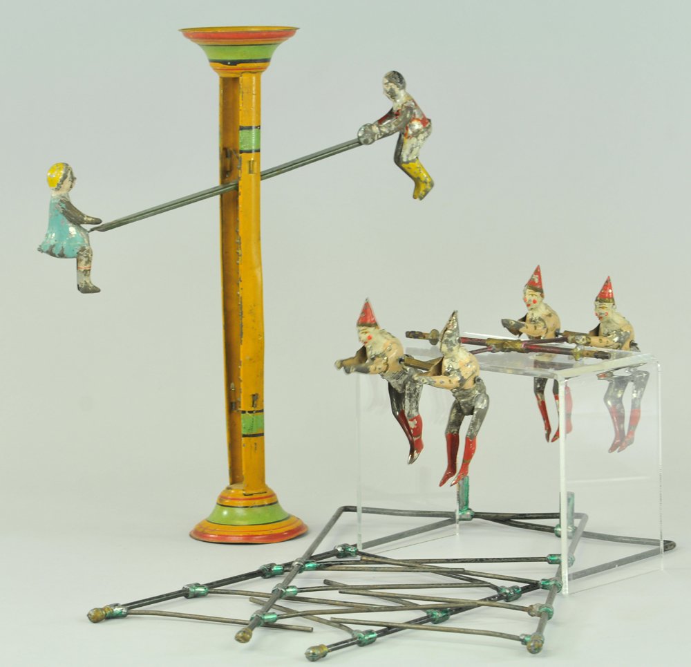 LOT OF TWO GRAVITY TOYS: Includes Gibbs hand painted tin boys on see-saw toy, able to flip over for continuous gravity action, and French clowns on bars, pairs able to traverse down bars. 14 1/2" - 16".