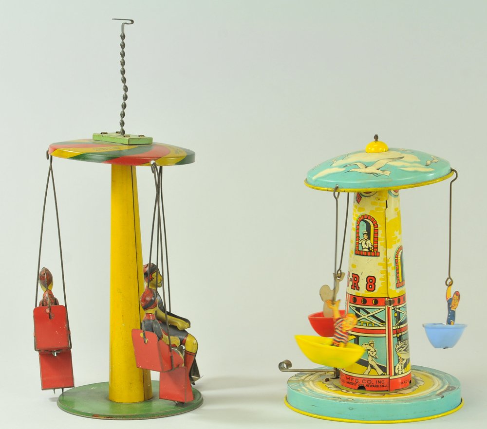 LOT OF TWO TIN ROUNDABOUTS: Includes Buffalo Toys spinning chairs ride, and Unique Art Canoe ride, made of plastic canoes, tin figures, tin base, levers control action. 9" - 10" h.