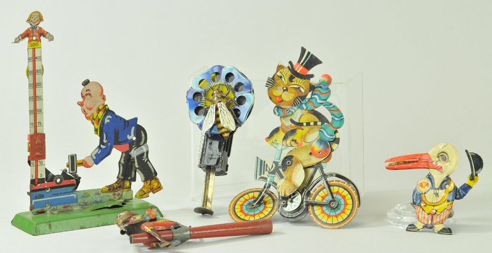 LOT OF PLUNGER & HAND HELD TOYS: Lithographed tin, includes clown at amusement park hammer strength toy, cat on bicycle plunger toy, fly on flower plunger toy, Monkey whistle, and Pelican with baby in mouth clicker. 2 3/4" - 6" h.