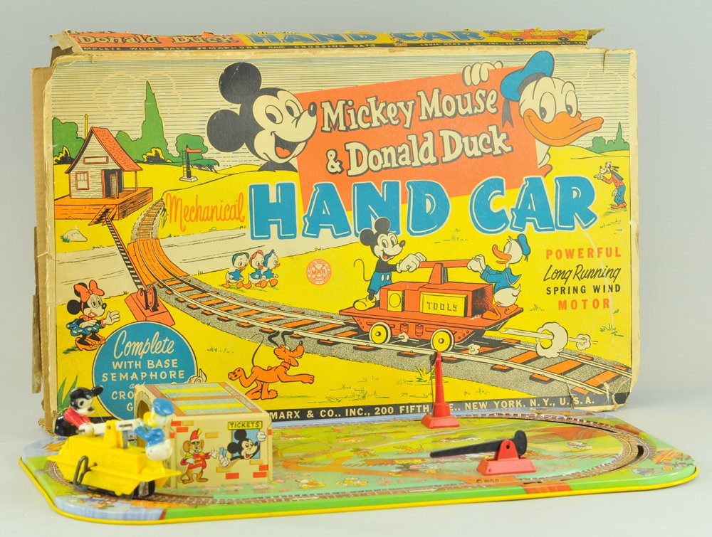MICKEY MOUSE & DONALD DUCK MECHANICAL HANDCAR: Large boxed set includes: wind-up plastic handcar with Mickey & Donald, operates on a big litho tin base, includes tattered box. Handcar 4 3/4" l., toy 20" l.
