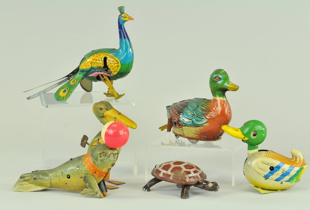 TIN TOY ANIMAL GROUPING: Amusing tin toy lot includes: Peacock, Ducks, Pelican, Turtle and Seal, all are key wind driven, very colorful overall, most have walking motions. 4 1/2" - 7" 1.