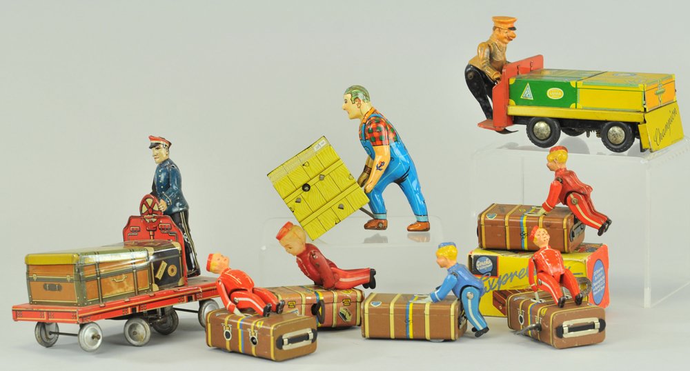 LOT OF TOY BAGGAGE HANDLERS: Interesting grouping of men and bell hops pushing luggage or cases, made of tin, some composition bodies, one has celluloid head, includes one Express Boy box. 2 1/2" - 6" l.