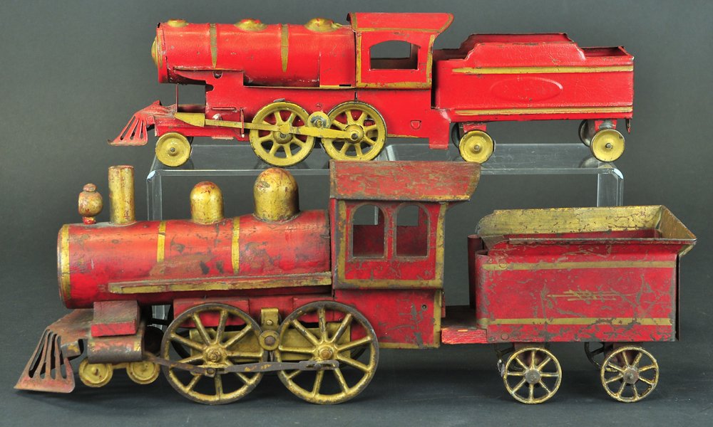 D.P. CLARK HILLCLIMBER LOCOMOTIVES: Wood & tin locomotive w/tin tender, wood floor, painted in red, 0-4-0 with four spoke wheels on tender, together with smaller loco and tender combo friction toy in heavy tinplate. 16" to 20" overall l