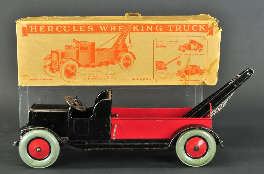 CHEIN HERCULES WRECKING TRUCK: Includes box, c. 1925, low open cab done in black w/red open service body, contains black boom, chain on boom, minor denting to fenders, wear to paint. 17 1/2" l.