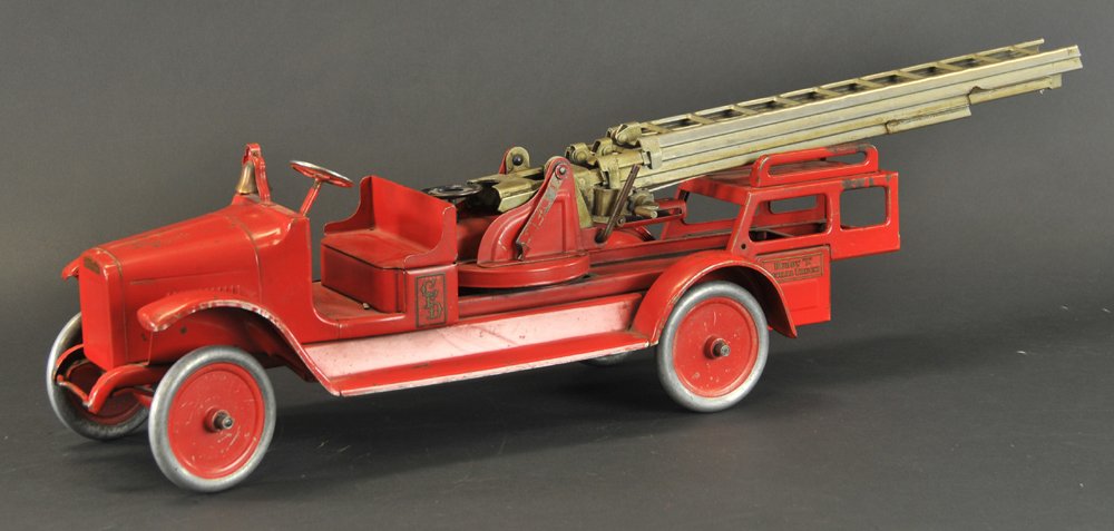 BUDDY 'L' AERIAL LADDER TRUCK: Pressed steel, done in red overall, nickel ladder, full length running boards, brass bell, ladder extends 4 1/2 feet, small hand wheel will rotate ladder, hydraulic aerial lift. 36" l.
