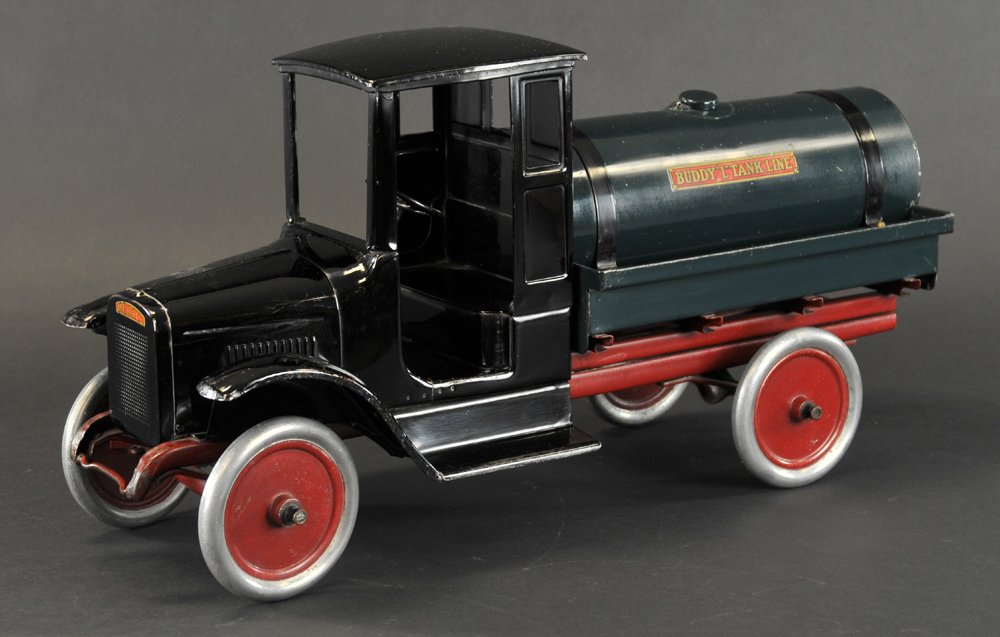 BUDDY 'L' TANK LINE TRUCK: c. 1920's, pressed steel, enclosed doorless cab painted in black, green tank body, aluminum wheels have red centers, side decals read "Buddy 'L' Tank Lines," original pull cord. 24" l.