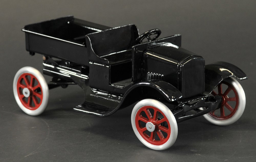 BUDDY 'L' FLIVVER DUMP TRUCK: Pressed steel, painted in black overall, open cab and tilts for unloading, spoke wheels. 11" l.
