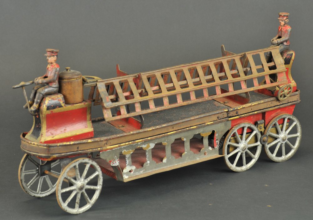 HILLCLIMBING LADDER TRUCK: D.P. Clark, c. 1904, pressed steel, wood and cast iron spoke wheels, features two seated drivers, enclosed area under flooring for hooks & apparatus. 19" l.