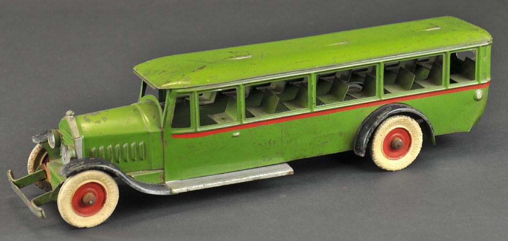 KINGSBURY PASSENGER BUS: 1925, pressed steel, painted in green overall, black fenders, interior bench seating, clockwork mechanism, white rubber tires. Ex. Donald Kaufman Collection. 16" l.