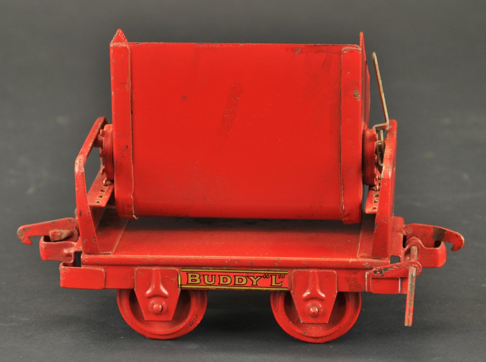 BUDDY 'L' ROCKER DUMP CAR: Pressed steel, painted in red, car is from the Industrial train set, decals on sides. 7 1/2" l.
