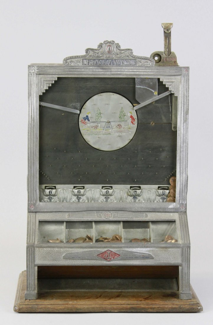 ROCKAWAY PENNY MACHINE: Jennings, 1930's, 1¢ to play and try to win more pennies, shooting penny on side allows travel through see-saw wheel, hitting certain slots wins the penny prize, includes key. 19" h. x 13" w.