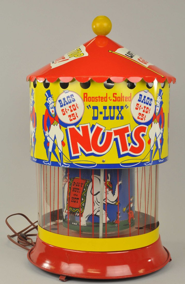 "D-LUX" PEANUT ROASTER MACHINE: Lithographed tin with plastic view, lift tent canopy to roast nuts, circus theme graphics on exterior and interior in bright colors. 21" h.