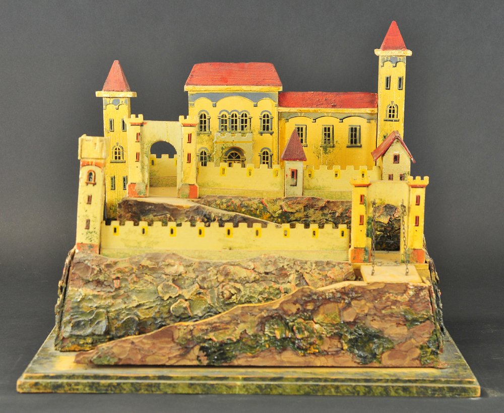 ELASTOLIN FORT: Composition landscape décor over painted wood, depicts fully ramped castle fort with extensive façade detail, trap door on base used for storage. 19" x 15".