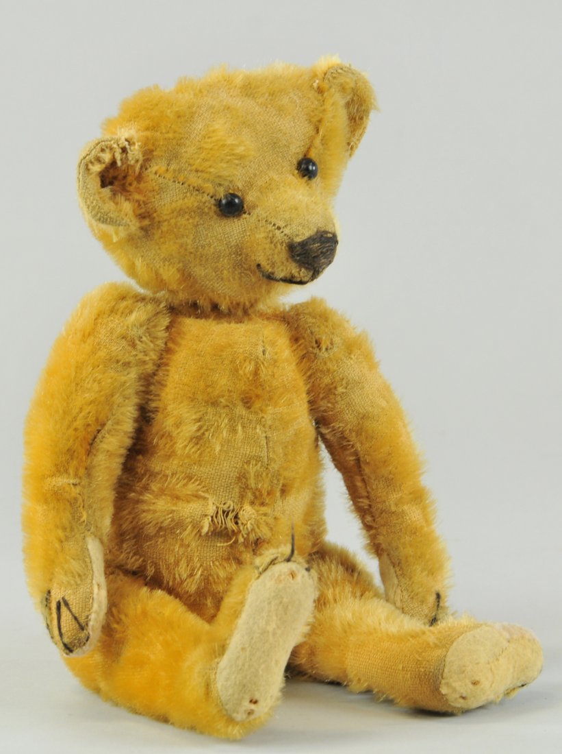 IDEAL TEDDY BEAR: Early 1904-1906, stitched nose, black bead eyes, stitched felt pads, straw filled, golden color. 12" h.